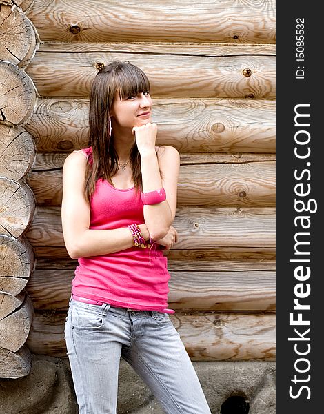 Girl standing near wooden wall. Girl standing near wooden wall