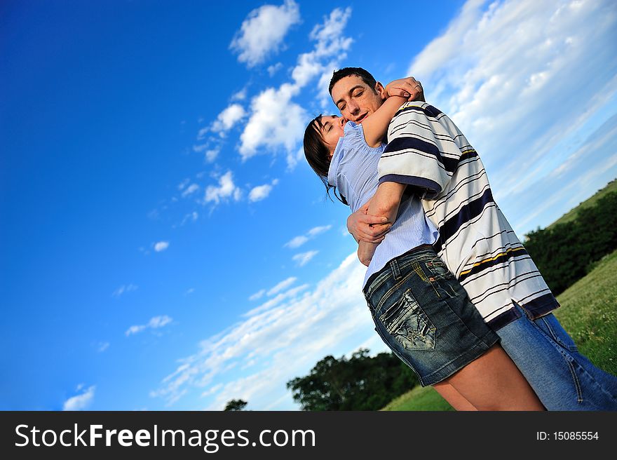 Couple outdoor, hugging with the eyes closed. Couple outdoor, hugging with the eyes closed