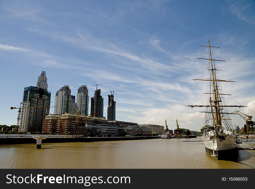 The 112 year old Sarmiento Frigate now shares the river with newly constructed high rises - Buenos Aires, Argentina. The 112 year old Sarmiento Frigate now shares the river with newly constructed high rises - Buenos Aires, Argentina.