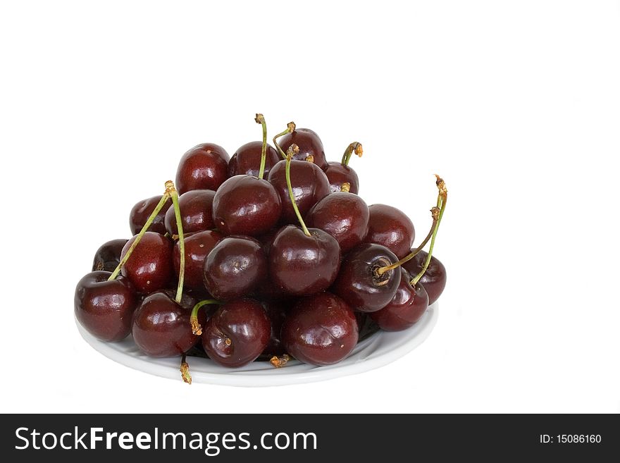 Fresh cherry on the saurce in isolated over white. Fresh cherry on the saurce in isolated over white