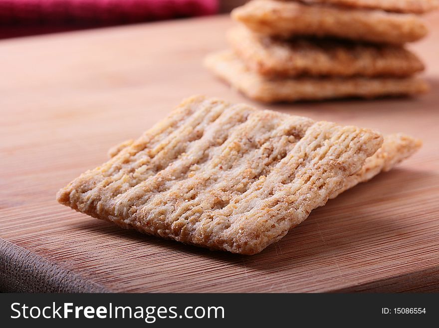 Wheat crackers on a kitchen board - a light meal.