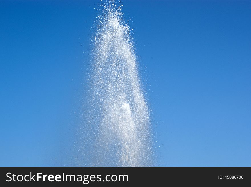 Water splash fountain with blue sky