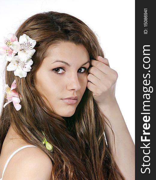 Studio portrait of beautiful young girl with flowers in hair. Studio portrait of beautiful young girl with flowers in hair