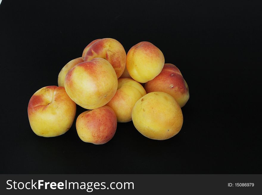 Ripe apricots in isolated over black