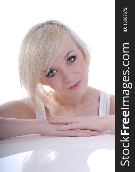 Photograph showing beautiful young blond woman in high key portrait isolated against white. Photograph showing beautiful young blond woman in high key portrait isolated against white