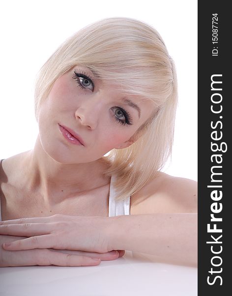 Photograph showing beautiful young blond woman in high key portrait isolated against white. Photograph showing beautiful young blond woman in high key portrait isolated against white