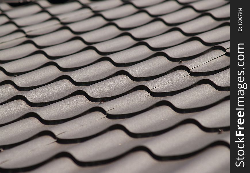 Dark brown corrugated roof. Light and shade