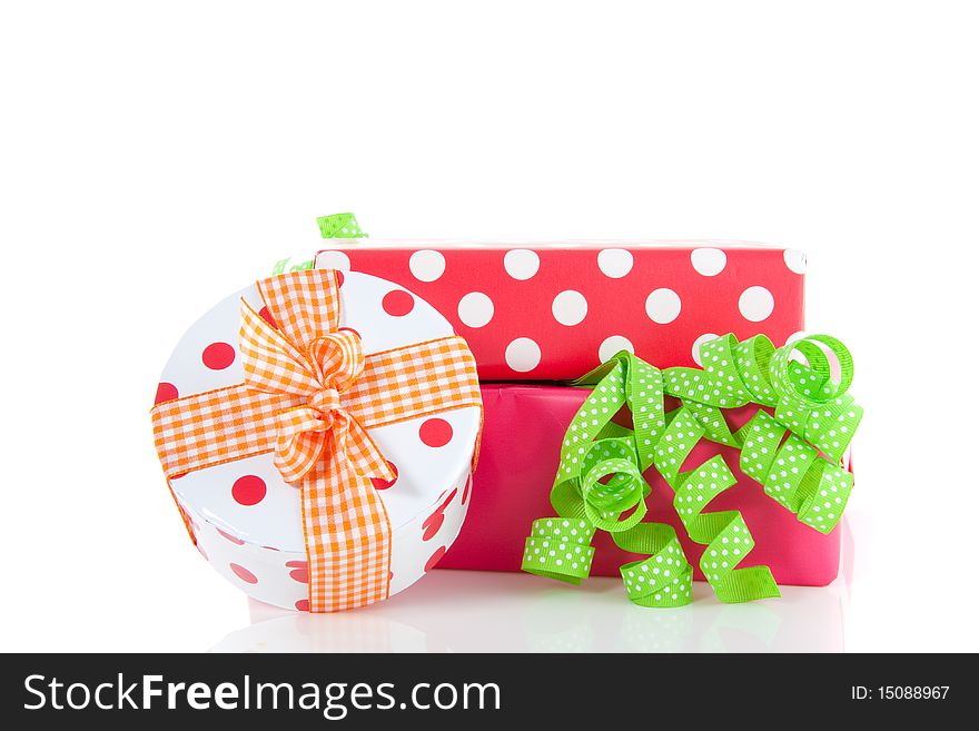 Colorful giftboxes decorated with ribbons and a bow isolated over white. Colorful giftboxes decorated with ribbons and a bow isolated over white