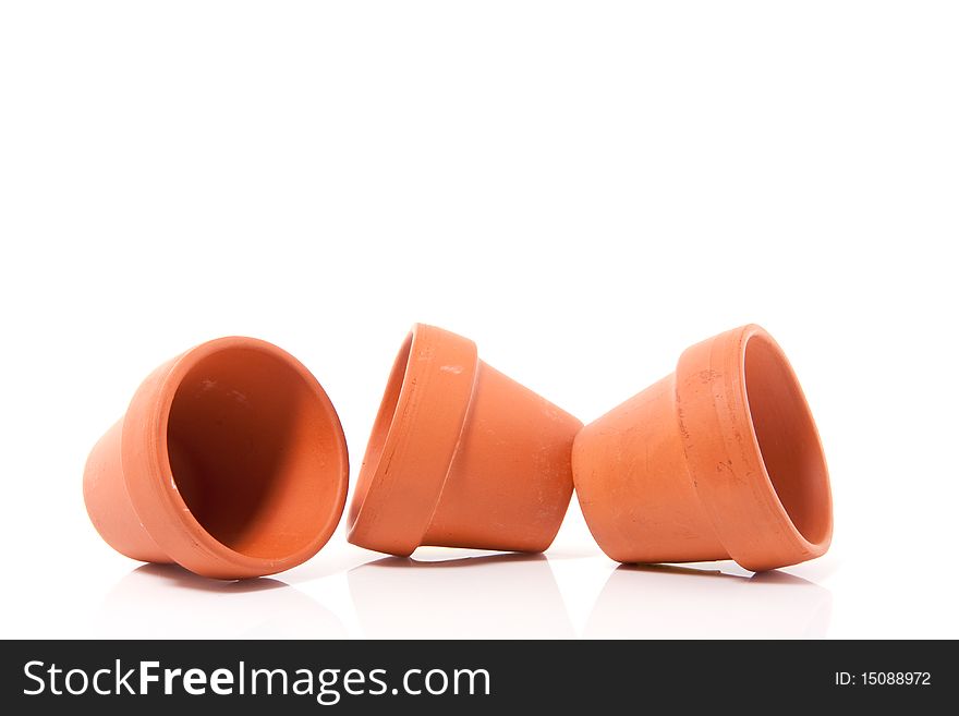 Three brown terracotta flower pots isolated over white