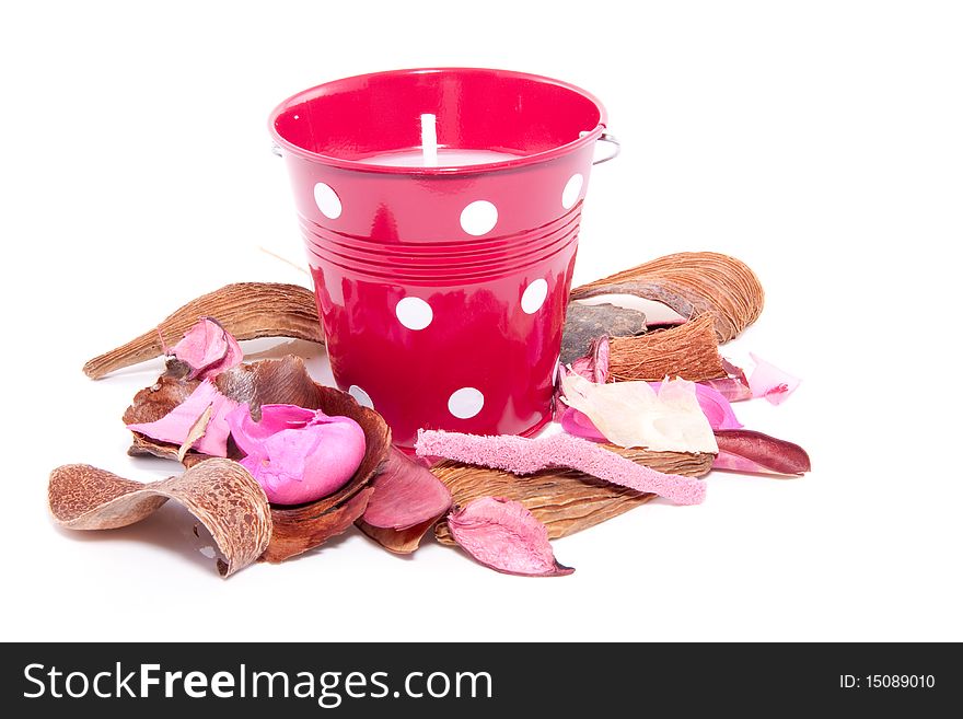 Colorful potpourri and a red candle in a bucket isolated over white. Colorful potpourri and a red candle in a bucket isolated over white