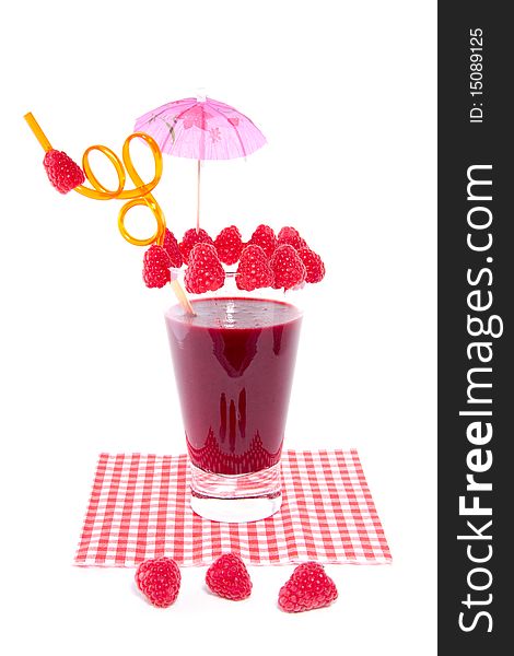 A fresh made glass of red fruit juice nicely decorated isolated over white. A fresh made glass of red fruit juice nicely decorated isolated over white