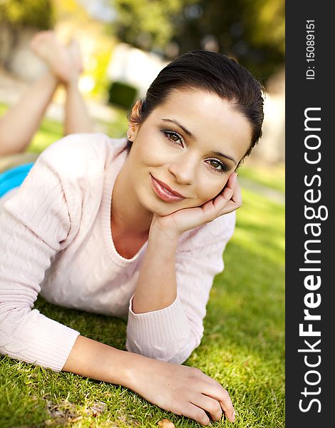 Pretty young woman laying in the grass. Pretty young woman laying in the grass