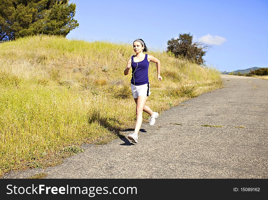 Young woman exercising outside in the sun