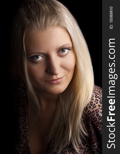 Portrait of a smiling young beautiful girl in close-up on a black background. Portrait of a smiling young beautiful girl in close-up on a black background