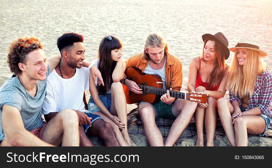 Happy Group Of Friend Having Party On The Beach.