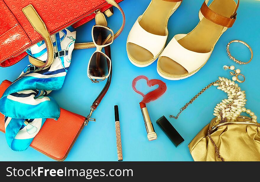 White summer sandals White pearl,red purse,red bag, Women  accessories ring watches 
hat  bow   cosmetic purse jewelry  fashion  pink gold on blue background sunglass red  lipstick copy space. White summer sandals White pearl,red purse,red bag, Women  accessories ring watches 
hat  bow   cosmetic purse jewelry  fashion  pink gold on blue background sunglass red  lipstick copy space