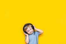 Little Cute Caucasian Blonde Boy In Headphones Posing Happy Smiling On Yellow Background Stock Photo Little Cute Caucasian Blonde Boy In Headphones Posing Happy Smiling On Yellow Background Stock Photo