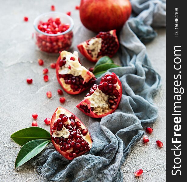 Ripe pomegranate fruits on  grey concrete background