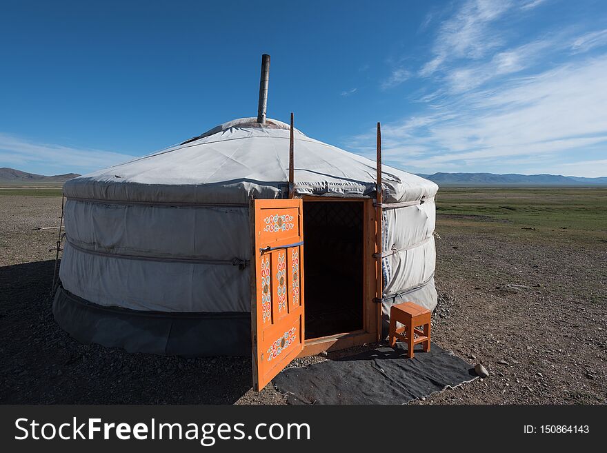 A ger with orange painted door at its summer location under sunny skies in central Mongolia, Asia. A ger with orange painted door at its summer location under sunny skies in central Mongolia, Asia