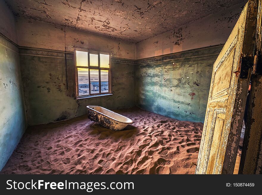 Old bathtube in the ruins of the mining town named Kolmanskop located in the Namib desert near Luderitz in Namibia, Southern Africa. Old bathtube in the ruins of the mining town named Kolmanskop located in the Namib desert near Luderitz in Namibia, Southern Africa