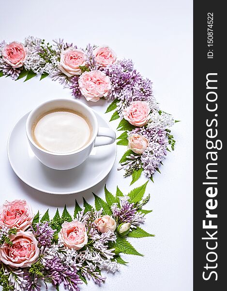 Vertical web banner. Frame of flowers: rose, lilac, rowan leaves and cup coffee on a white background. Floral pattern