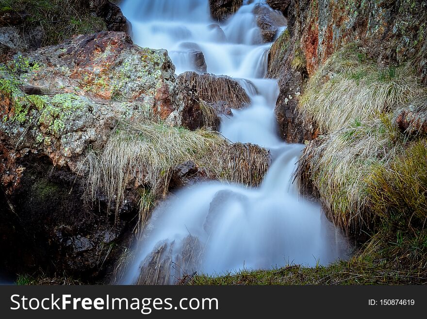 Mountain stream waterfall landscape at sunset, Pyrenees