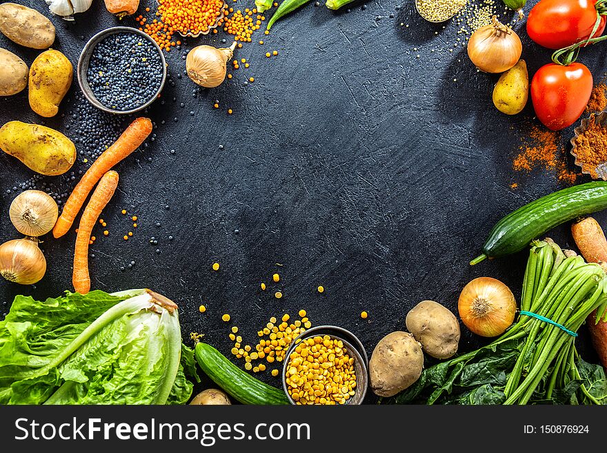 Variety of fresh tasty vegetables on dark background