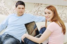 Young Couple Working On Laptop At Home Royalty Free Stock Photo