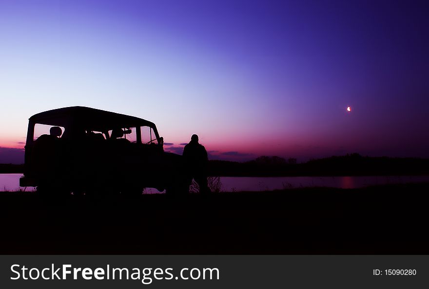 Off-road car, person look to sunrise on lake. Off-road car, person look to sunrise on lake