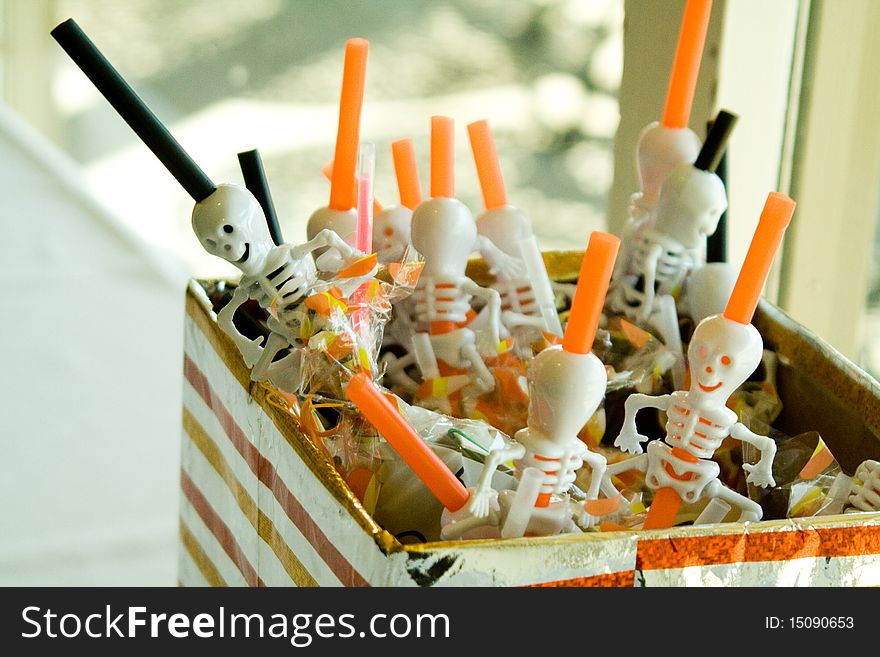 A box of orange and black skeleton Halloween straws. A box of orange and black skeleton Halloween straws.