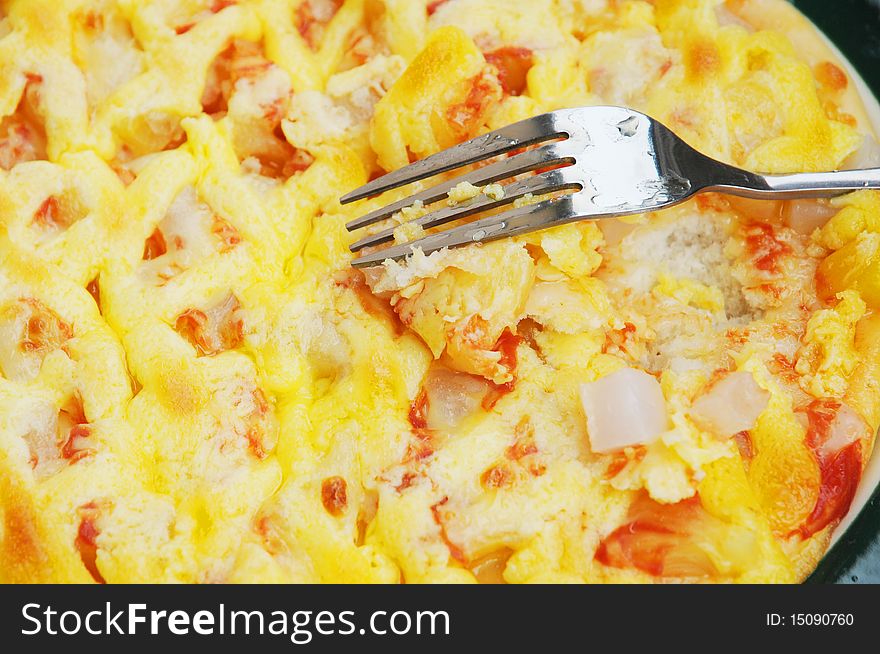 The stainless steel fork and fruit pizza cake.