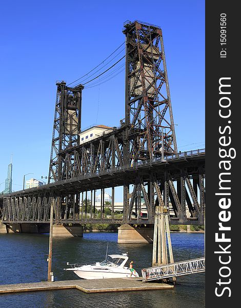 The steel bridge against a blue sky and a moored yacht on the Willamette river. The steel bridge against a blue sky and a moored yacht on the Willamette river.