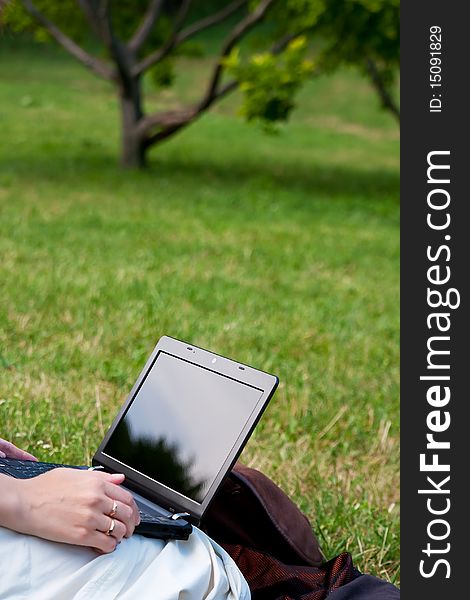 Woman with modern netbook in summer park. Woman with modern netbook in summer park