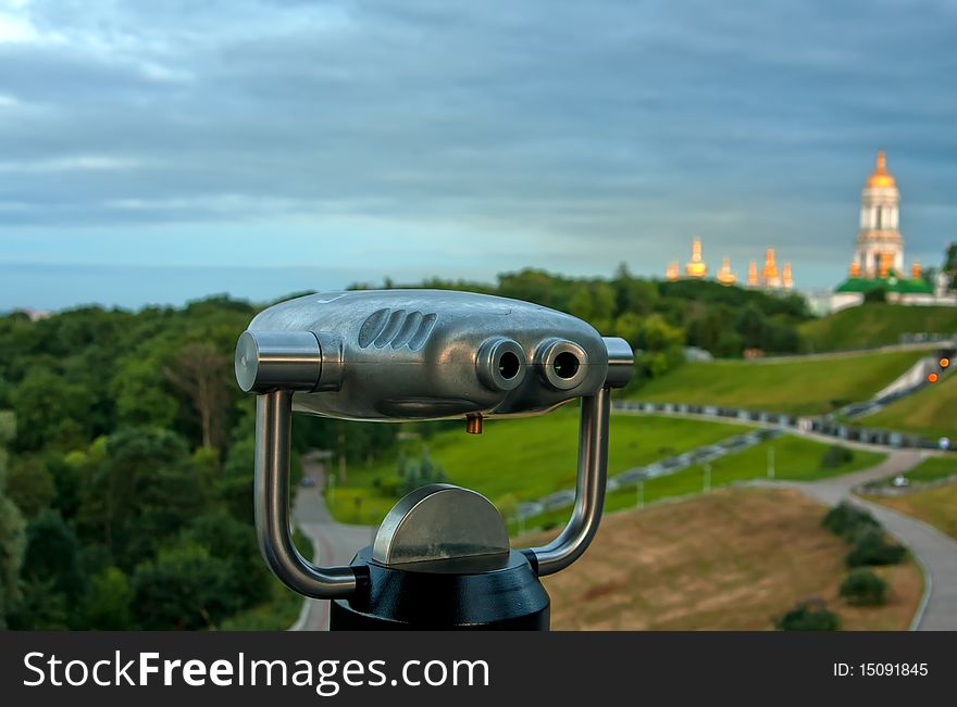 Pay Binoculars and Kyiv cityscape with orthodox cathedral - Lavra