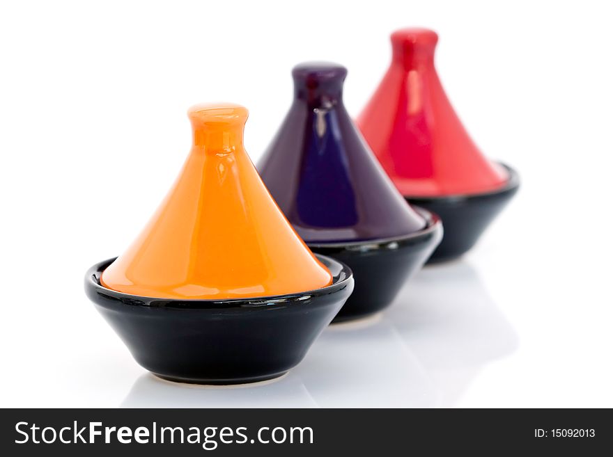 Three traditional colorful Moroccan tajine cooking pots, isolated on white background. Three traditional colorful Moroccan tajine cooking pots, isolated on white background.