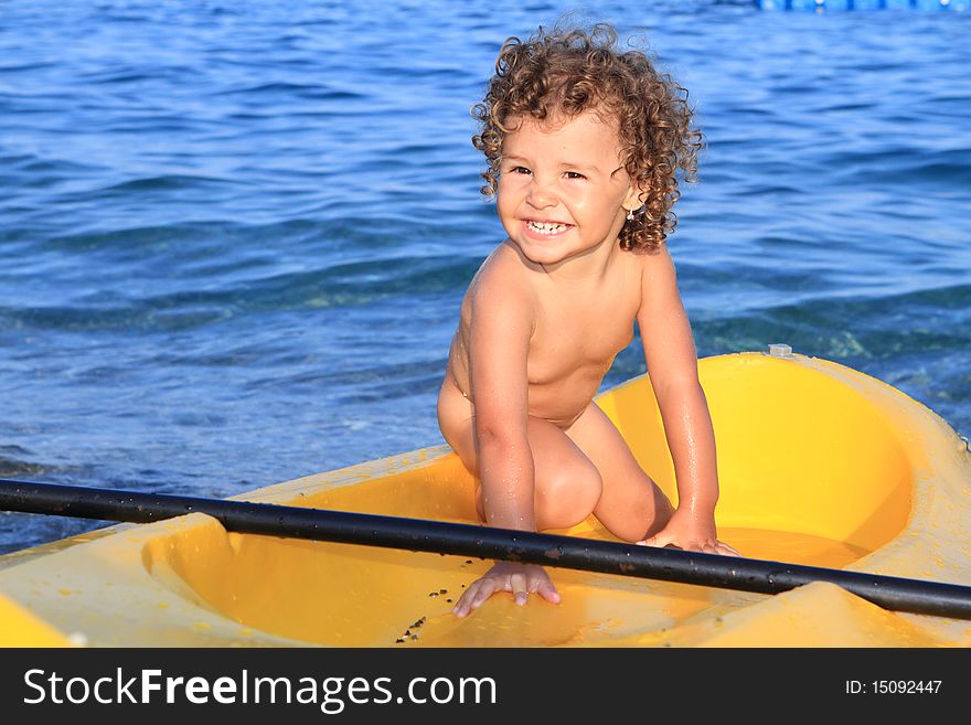 Baby girl in canoe and sea. Baby girl in canoe and sea