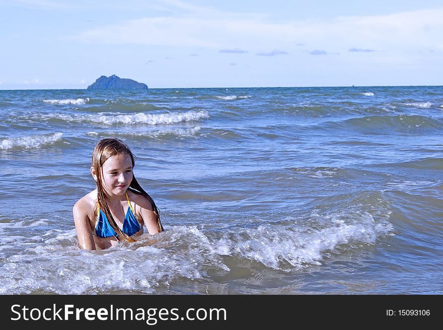 The girl learns to swimm in the sea. Southern - Chinese sea. Coast Borneo. Day.