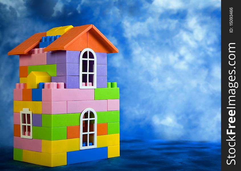 Toy house model on a blue sky background