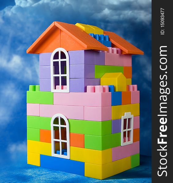 Toy house model on a blue sky background