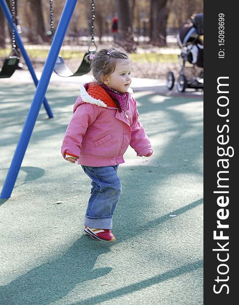 Running young girl on outdoor playground. Running young girl on outdoor playground