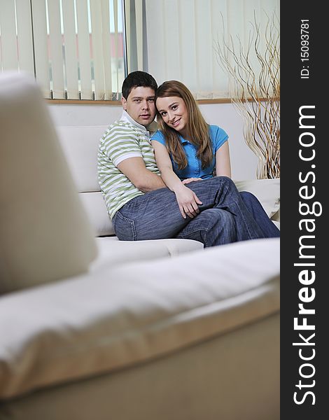 Happy young couple relax at home in modern and bright living room. Happy young couple relax at home in modern and bright living room