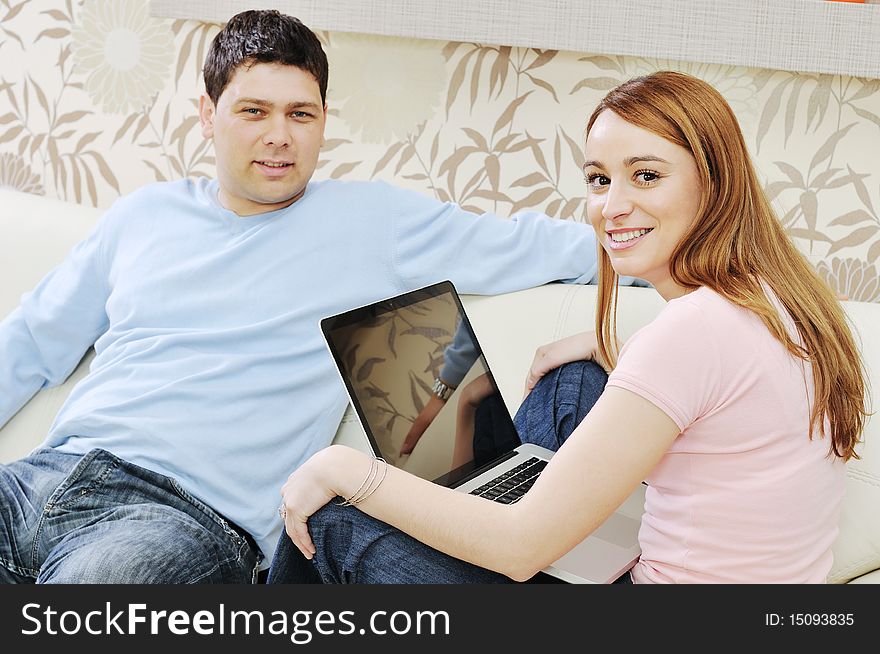 Young couple at home with  modern livingroom indoor working on laptop on house finance and planing. Young couple at home with  modern livingroom indoor working on laptop on house finance and planing