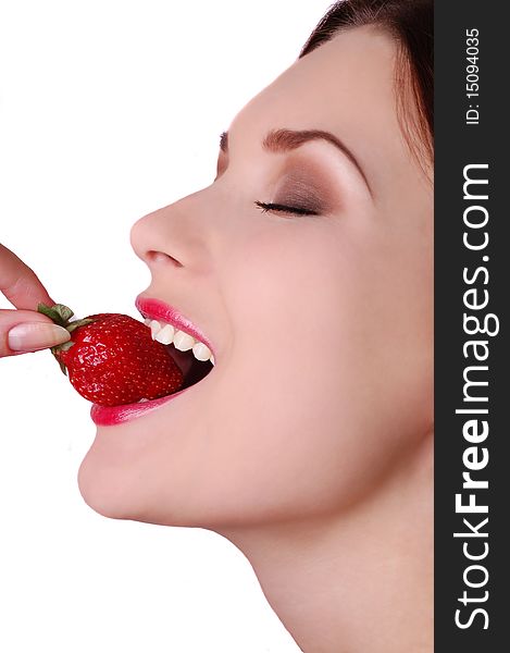 Profile of beautiful woman biting strawberry isolated on white