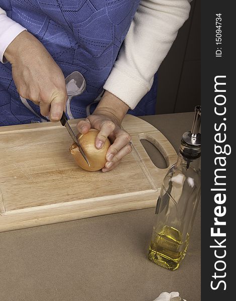 Chef cutting through an onion with a knife. Chef cutting through an onion with a knife