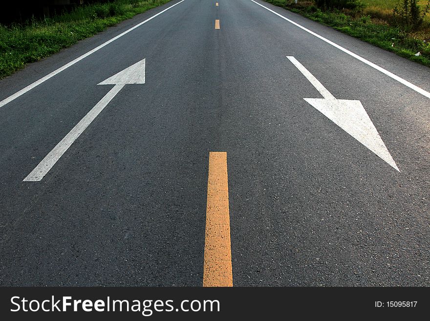 White arrow direction on road. White arrow direction on road