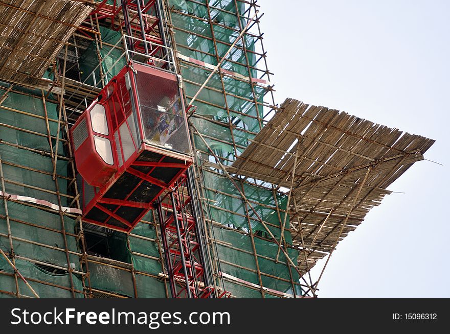 A skyscraper in construction phase with construction equipment on it