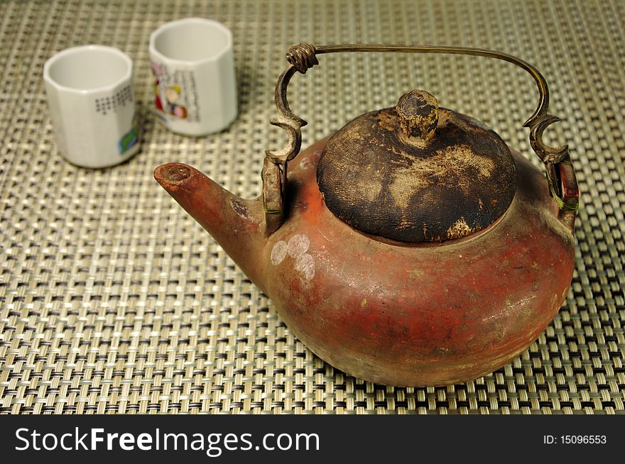 Antique chinese style teapot and two cup. Antique chinese style teapot and two cup.