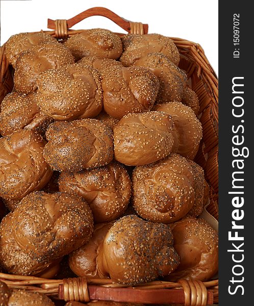 Fresh bread rolls in a wicker basket on a white background. Fresh bread rolls in a wicker basket on a white background.