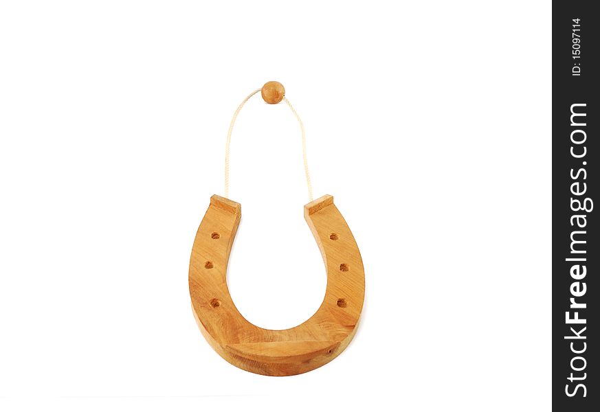 The wooden horseshoe in the form of a suspension bracket is isolated on a white background