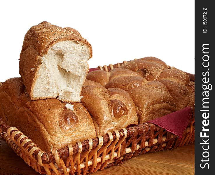 Fresh bread in a wicker basket on a white background . Fresh bread in a wicker basket on a white background .